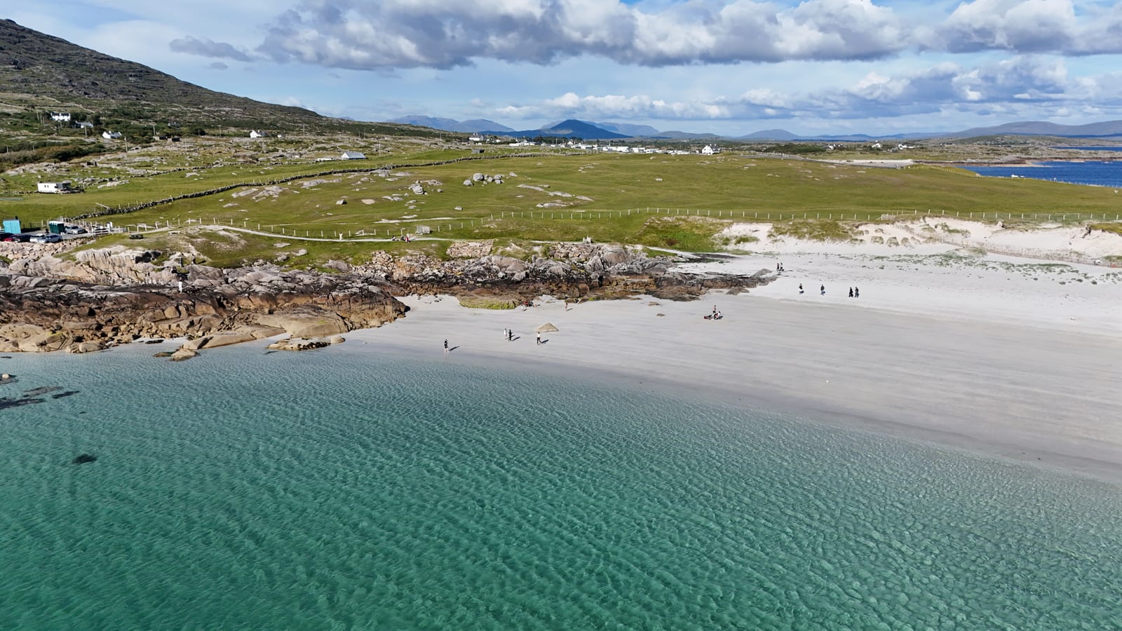 Aerial view of a beach with mountains behind